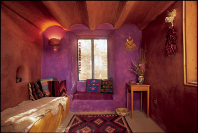 Interior walls adorned with highly polished orange clay and lime plaster with purple fresco color